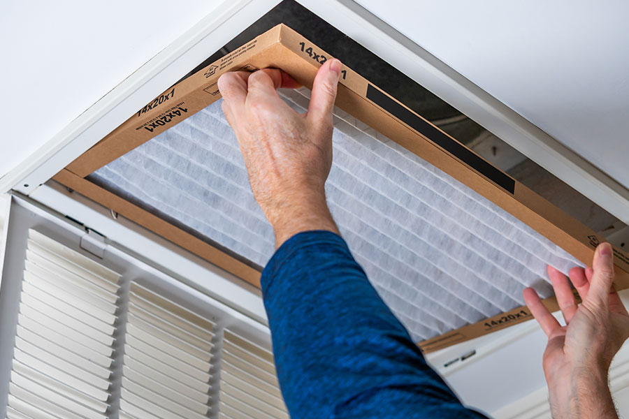 A professional technician inspects an air duct and changes the filter at this Springfield, IL residence.